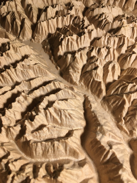 detail of three-dimensional wood-carved relief map of the mountains of Valhalla & Kokanee Glacier, British Columbia, Canada