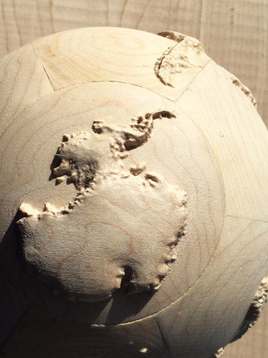 detail of fully three-dimensional 6-inch wood-carved terrestrial relief globe