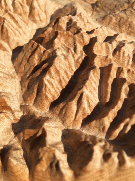 detail of three-dimensional wood-carved relief map of the mountains around Mount Revelstoke in the Selkirk Mountains, British Columbia, Canada