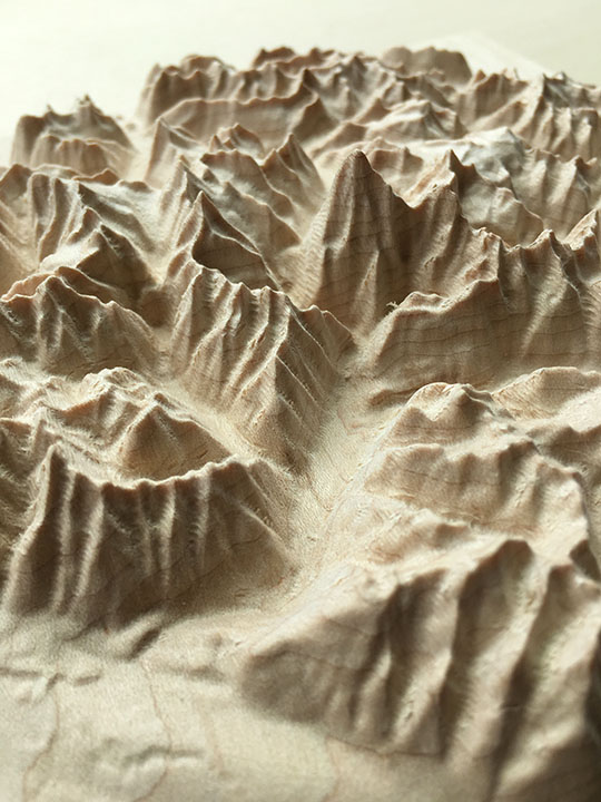 detail of three-dimensional wood-carved relief map of the Canadian Rockies around Mount Robson, British Columbia, Canada