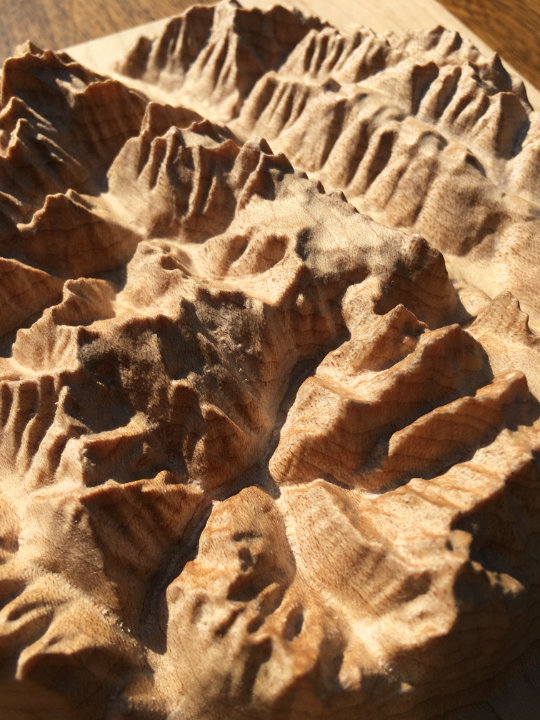 detail of three-dimensional wood-carved relief map of the mountains around Rogers Pass in Glacier National Park, British Columbia, Canada