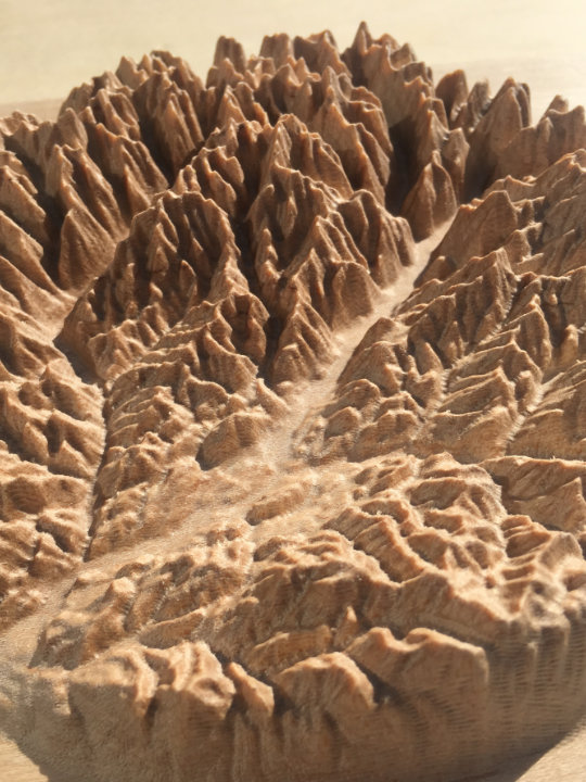 detail of three-dimensional wood-carved relief map of the mountains of the Methow Valley in the North Cascades, Washington, United States