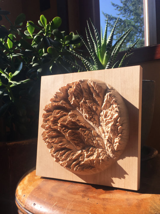 detail of three-dimensional wood-carved relief map of the mountains of the Methow Valley in the North Cascades, Washington, United States