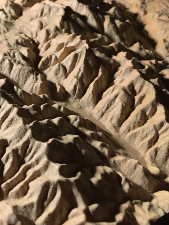 detail of three-dimensional wood-carved relief map of the mountains of the Rossland Range in the Kootenays, British Columbia, Canada