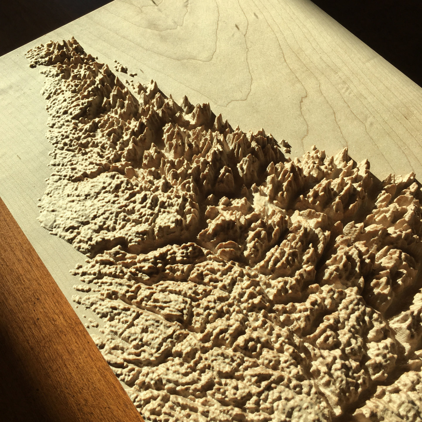 three-dimensional wood-carved relief map of the Torngat Mountains, Labrador, Canada