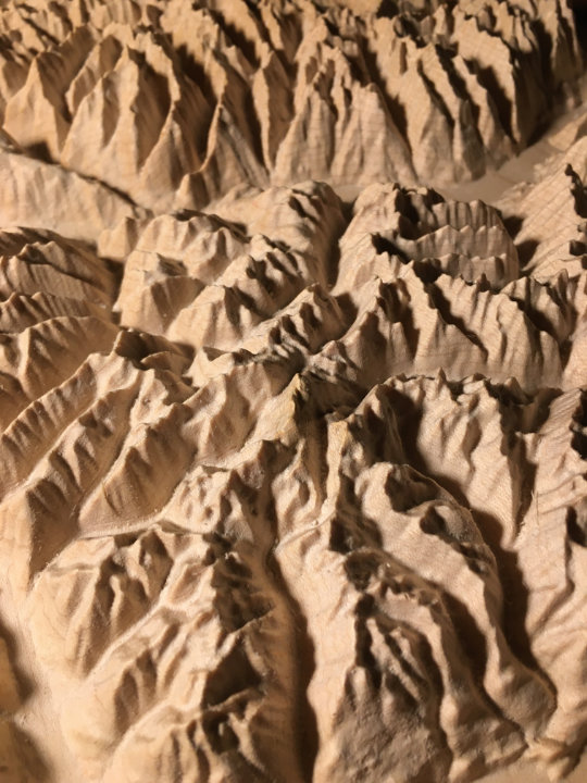 detail of three-dimensional wood-carved relief map of the mountains of Valhalla & Kokanee Glacier, British Columbia, Canada