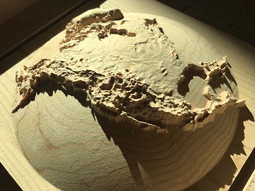 3D dome relief map of North America, carved out of wood