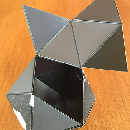 icosahedral globe partially folded from magnetic triangles