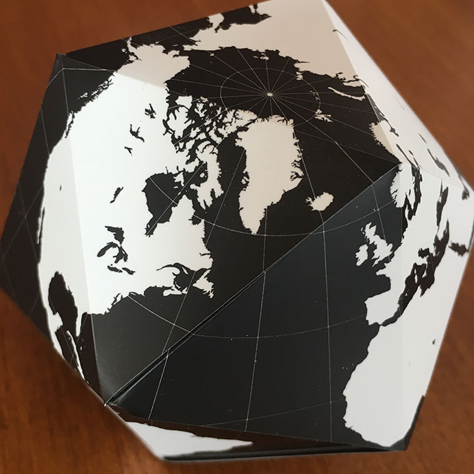 icosahedral globe folded from magnetic triangles with the continents in white and the oceans in black