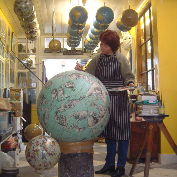 globemaker hand-colouring a globe at Greaves and Thomas globemakers