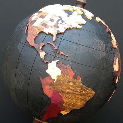 wooden globe from Spirals by Steve made from hexagonal and pentagonal pieces with black oceans and coloured states and countries